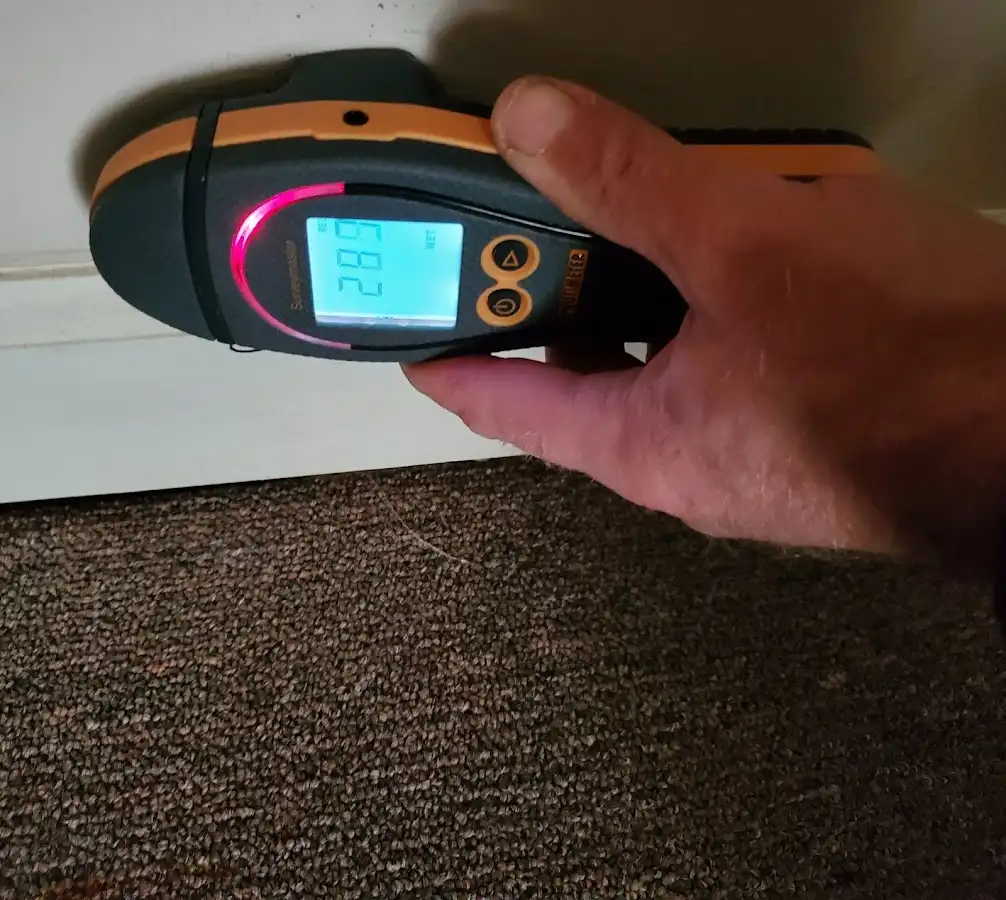 Moisture detection at baseboard during Storm Damage Restoration in Fort Smith